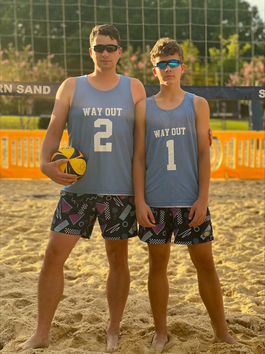Leo Marushevskyi (left) and his son Lev Marushevskyi, the father-son team behind VolleyLens, on a beach volleyball court
